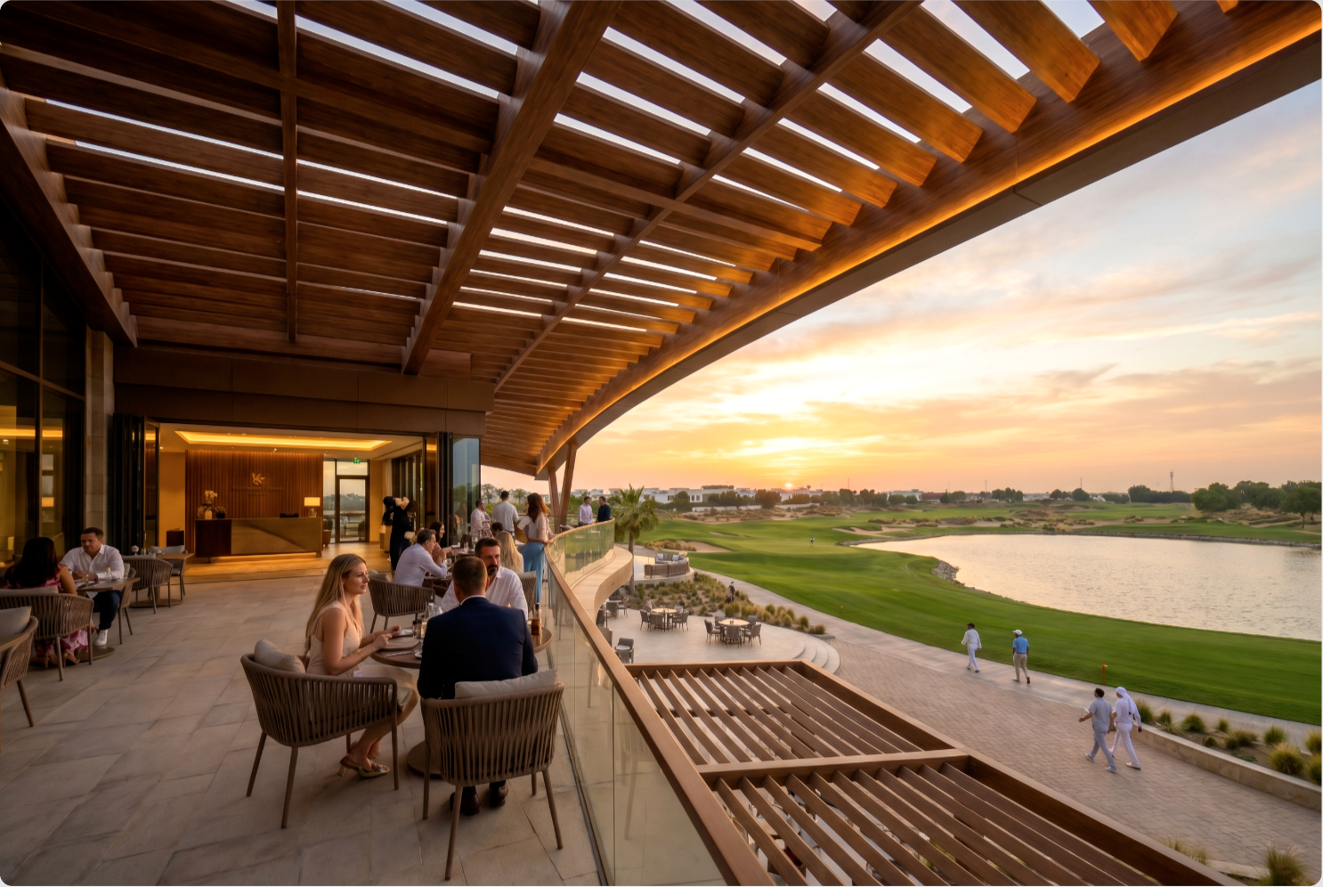 The Greens — elevated first-floor dining terrace overlooking the lake and course at dusk