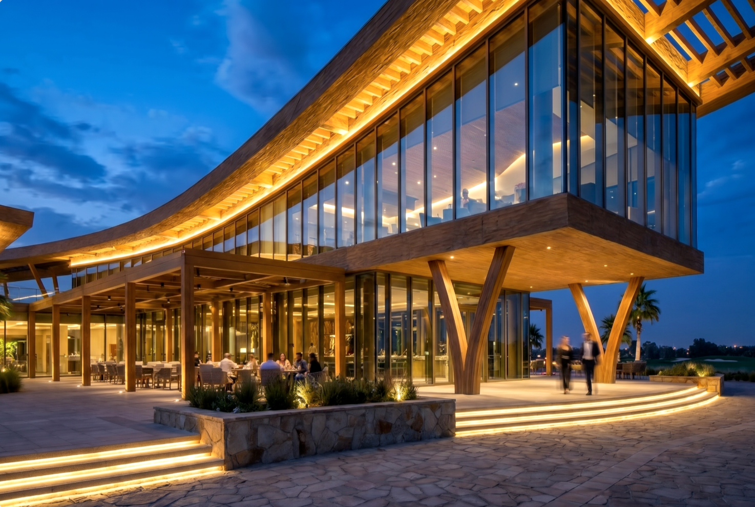 The Greens — blue-hour close view of the ground-floor restaurant entry overlooking the course